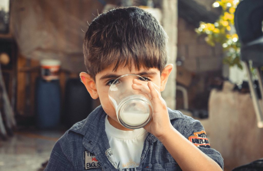 Photo of young boy looking like he is really enjoying his smoothie. Enhancing this website Iron Rich Smoothie Recipes for Kids